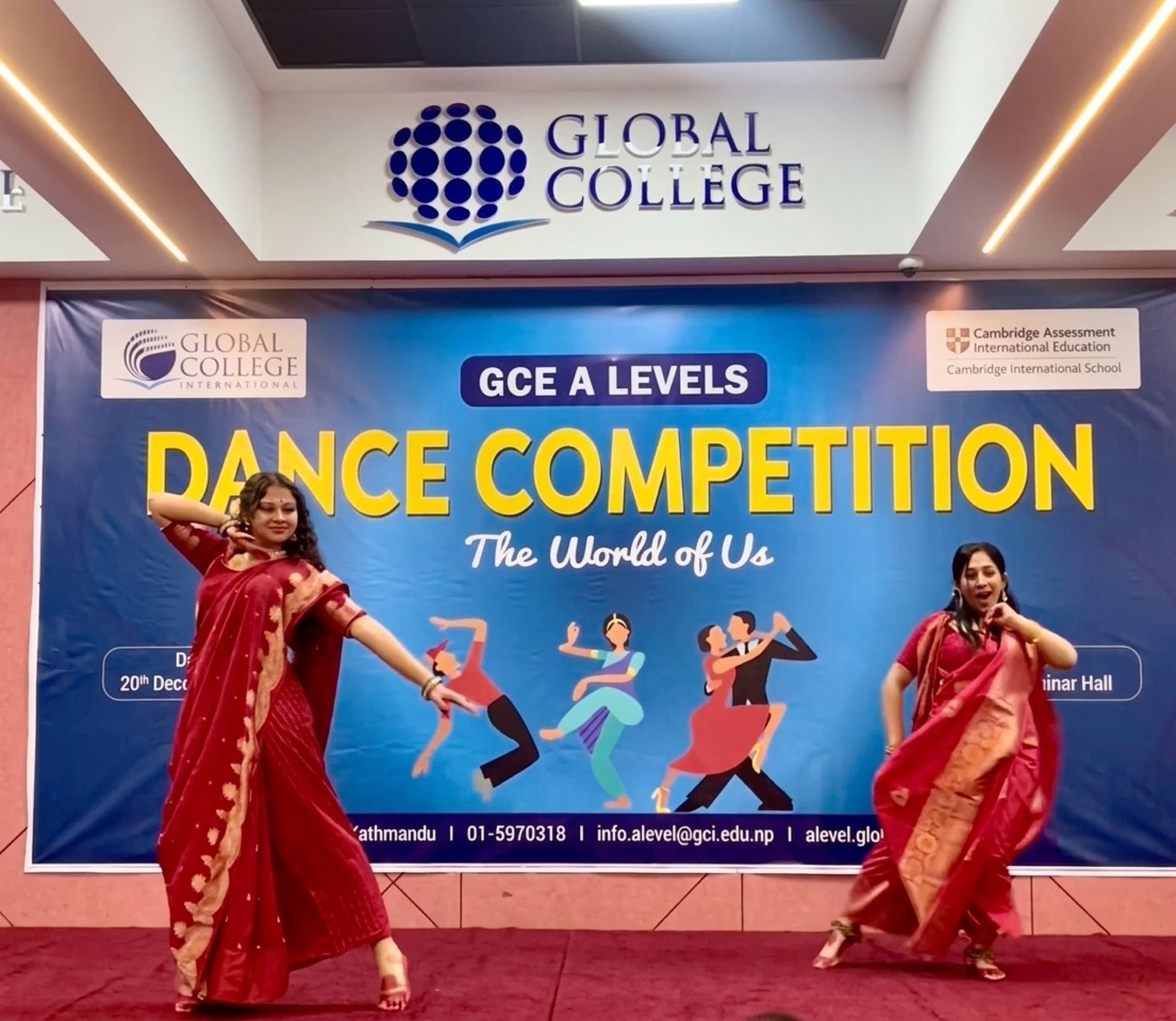 Two dancers performing Dola Re Dola in red sarees