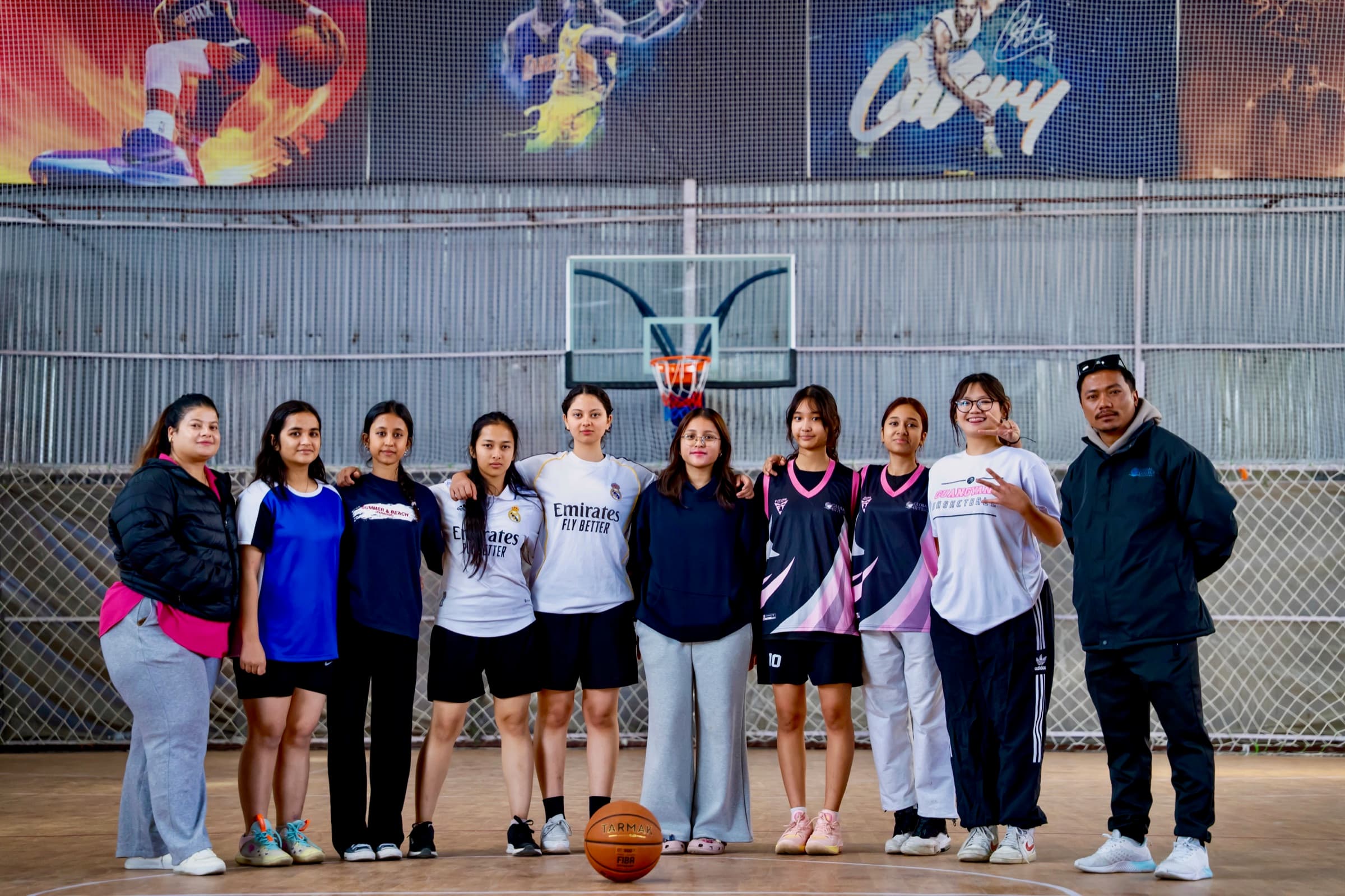 GCI girls basketball team posing on court