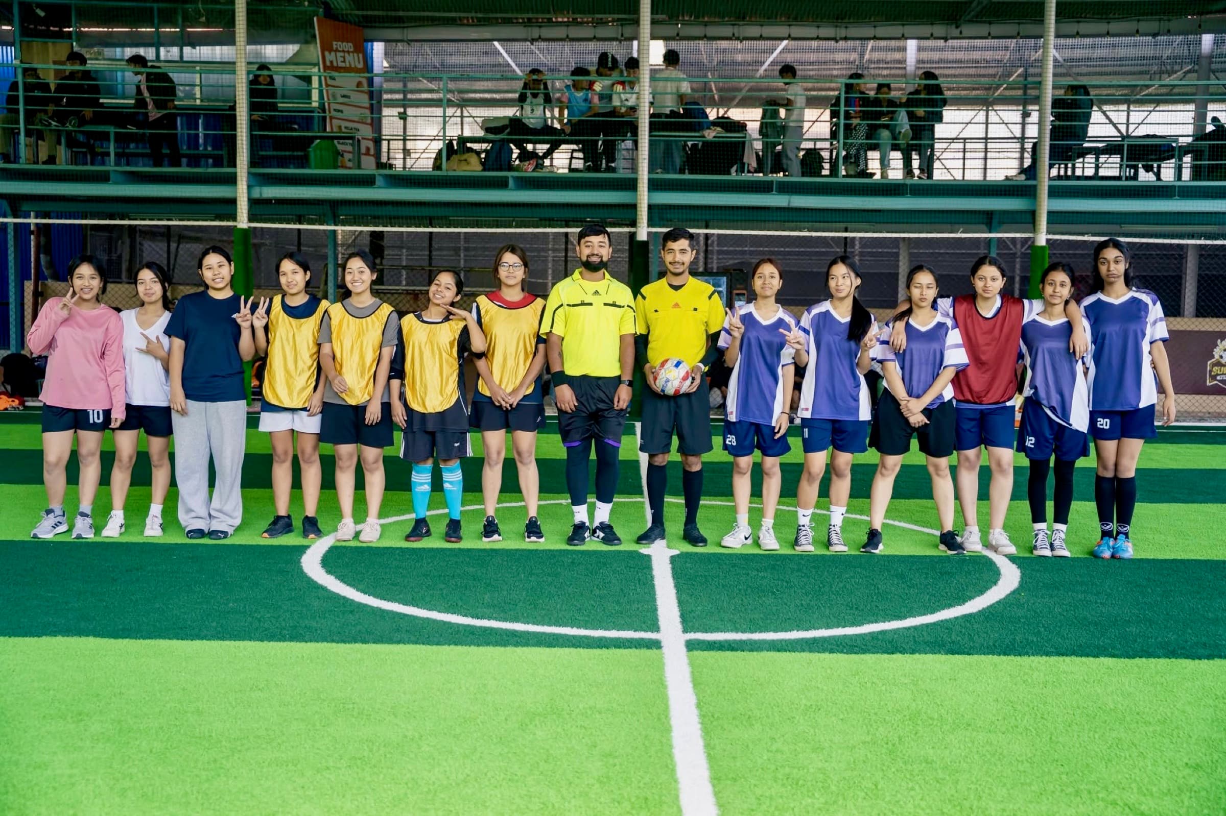 Two girls football teams lined up before a match